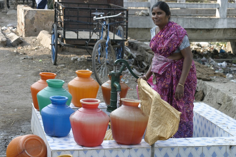 Waterwheel - A woman draws water at a communtiy hand pump.  (Madurai)